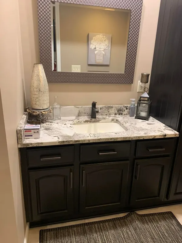Bathroom vanity with a stone top and black cabinet