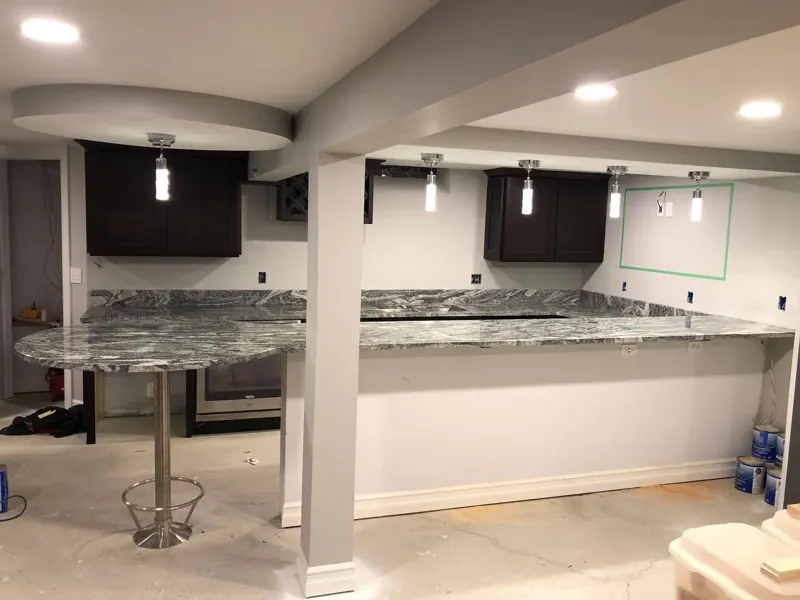 Granite bar top and round bistro table in a finished basement