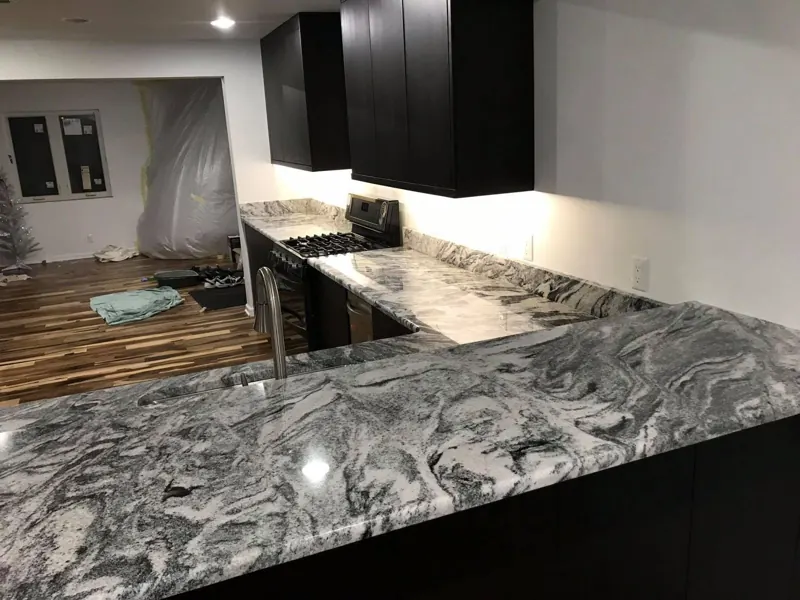 Granite counters on black cabinets with a range