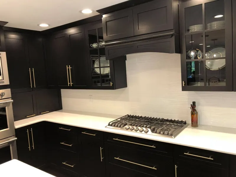 White countertop with a farmhouse sink under a window