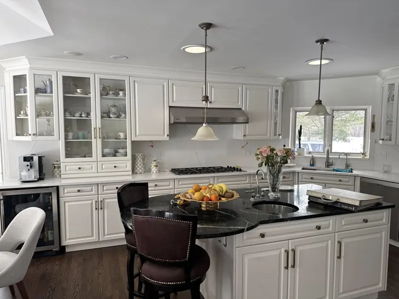 White kitchen with a black stone island